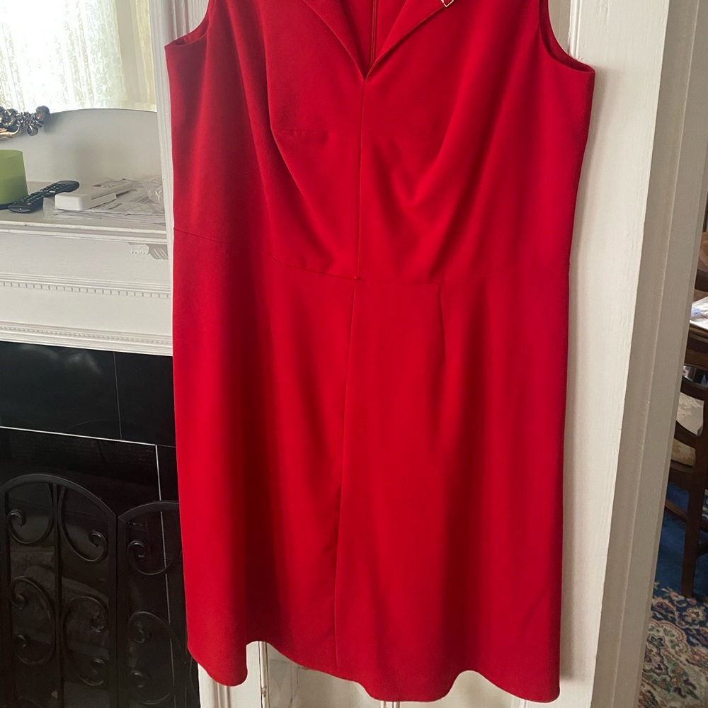 Like new Calvin Klein red dress. Zippered back, peephole front, knee length.